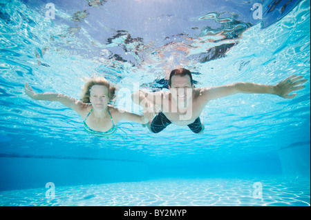 Mid adult couple swimming underwater Stock Photo