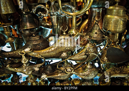 ISTANBUL, Turkey — Traditional brass lamps hang on display in a metalwork shop in Istanbul's historic Grand Bazaar. These ornate lighting fixtures, reflecting Ottoman design influences, represent one of many traditional crafts still practiced in the centuries-old marketplace. The handcrafted lamps exemplify the continuing tradition of Turkish metalwork in the bazaar's specialized shopping districts. Stock Photo