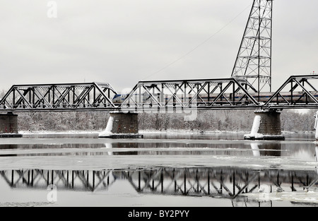 Amtrak Train passing Livingston Avenue Bridge over Hudson River in Albany, New York. Stock Photo