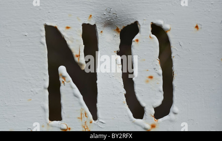 No cut out in an iron sign, painted white with some rust.  The 'NO' has a dark background Stock Photo