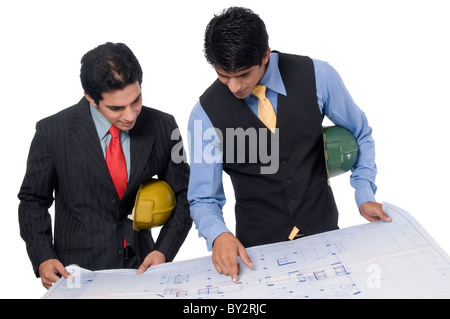 Two Indian professionals looking at a blueprint Stock Photo