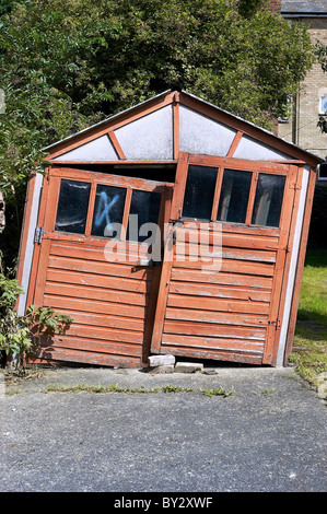 Damaged shed in back garden. Stock Photo