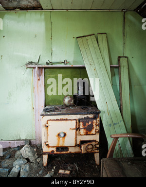 Wood burning stove in derelict croft house, Berneray, Outer Hebrides, Scotland Stock Photo