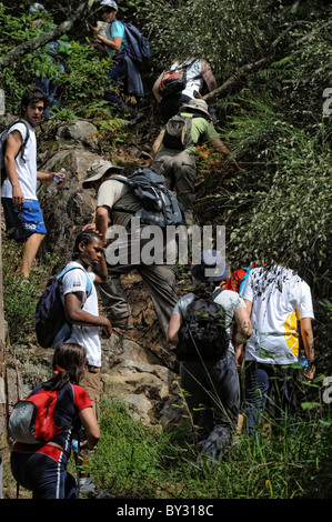 Hikers on a trail up hill Stock Photo