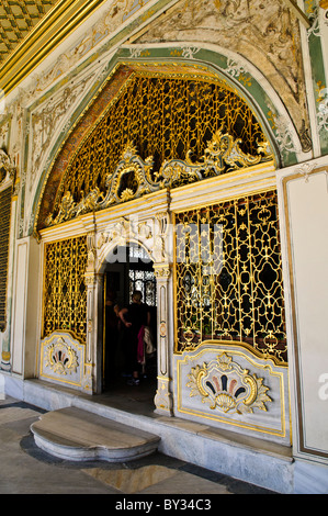 ISTANBUL, Turkey / Türkiye — Ornate decorations around the main exterior entrance of the Imperial Council building (in Turkish: Dîvân-ı Hümâyûn) inside the Topkapi Palace in Istanbul. This was the chamber in which the ministers of state, council ministers (Dîvân Heyeti), the Imperial Council, consisting of the Grand Vizier (Paşa Kapısı), viziers, and other leading officials of the Ottoman state, held meetings. It is also called Kubbealtı, which means 'under the dome', in reference to the dome in the council main hall. It is situated in the northwestern corner of the courtyard next to the Gate  Stock Photo