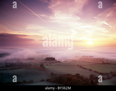 Sunrise over the Vale of Pewsey viewed from Martinsell Hill in Wiltshire, England. Stock Photo