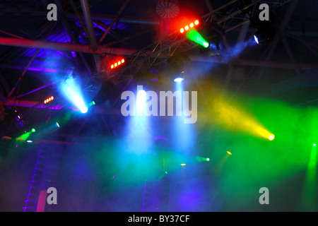 lighting equipment at concert - colored spotlights on ceiling in smoke Stock Photo