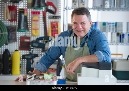 USA, New Jersey, Jersey City, Portrait of hardware shop owner at counter Stock Photo