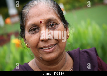 Portrait of a smiley Indian lady in a garden Stock Photo