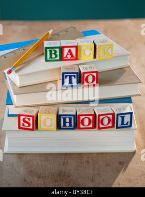 Back to school building blocks on stacked books pencil and ruler Stock Photo