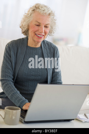 USA, New Jersey, Jersey City, Senior woman using laptop at home Stock Photo