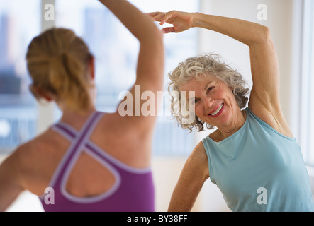 USA, New Jersey, Jersey City, Senior woman with fitness instructor at gym Stock Photo