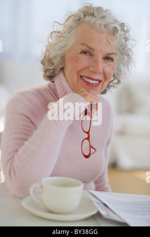 USA, New Jersey, Jersey City, Portrait of senior woman holding glasses Stock Photo