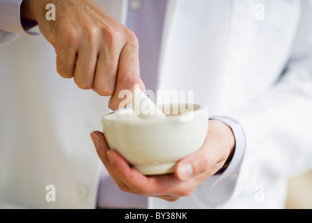 USA, New Jersey, Jersey City, Doctor preparing medicine using mortar and pestle Stock Photo
