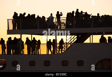 USA, New York City, Silhouette of passengers on tourboat Stock Photo