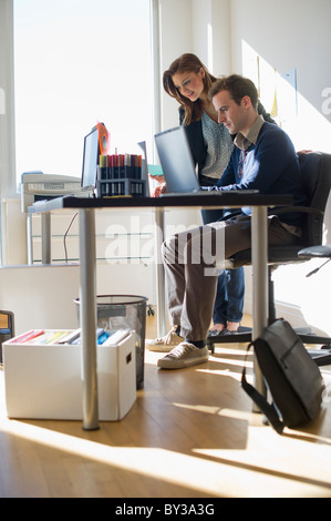 USA, New Jersey, Jersey City, Two young people in office Stock Photo