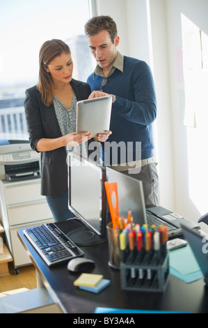 USA, New Jersey, Jersey City, Two young people in office Stock Photo