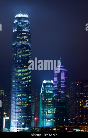 Hong Kong Island China city skyline of Central District at night as seen across Victoria Harbour from Kowloon Two Ifc towers Stock Photo