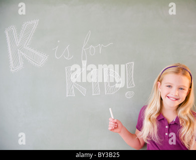 USA, New Jersey, Jersey City, Girl (8-9) writing on blackboard Stock Photo