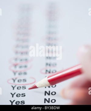 USA, New Jersey, Jersey City, Close-up view of woman's hand filling in form Stock Photo