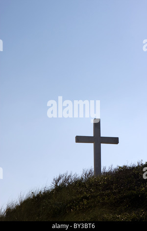 Silhouette of a cross on a hill with a clear blue sky background located on Pensacola Beach, Florida. Can be used for many appli Stock Photo