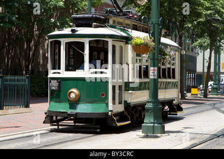 Passengers ride an electric trolley car down Main Street. Stock Photo
