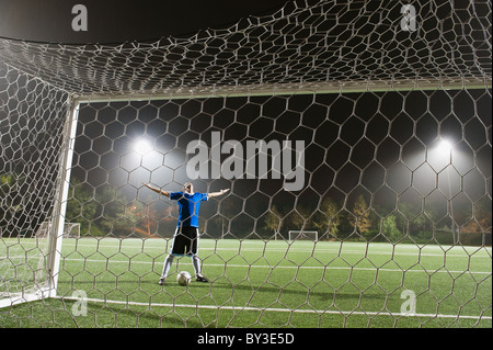 USA, California, Ladera Ranch, goalie on illuminated soccer field at night Stock Photo
