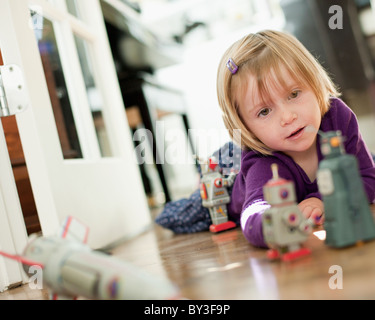 Girl lying on floor playing with her golden retriever dog Stock Photo ...