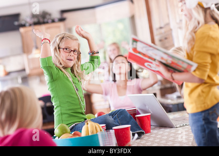 USA, Utah, family portrait of sisters (6-7, 8-9, 12-13, 14-15, 16-17) having fun at table Stock Photo