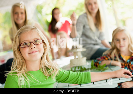 USA, Utah, family portrait of sisters (6-7, 8-9, 12-13, 14-15, 16-17) at table Stock Photo