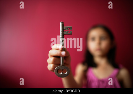 Girl holds key in hand Stock Photo