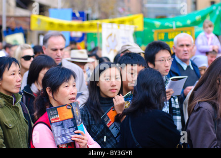 Catholic procession through city streets. Migrants from many cultures are among the people participating. Stock Photo