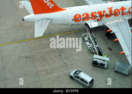 Baggage handlers loading hold luggage onto an aircraft - Gatwick, UK Stock Photo