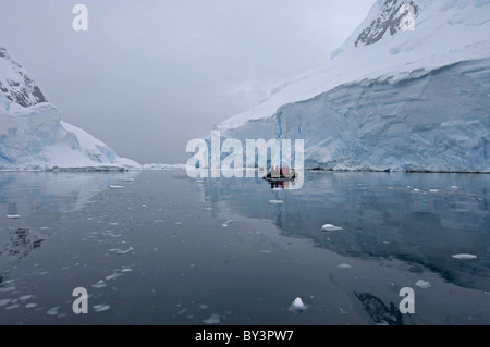 Tourists in a zodiac at Cape Renard in Lemaire Channel near Antarctic Peninsula, Antarctica Stock Photo