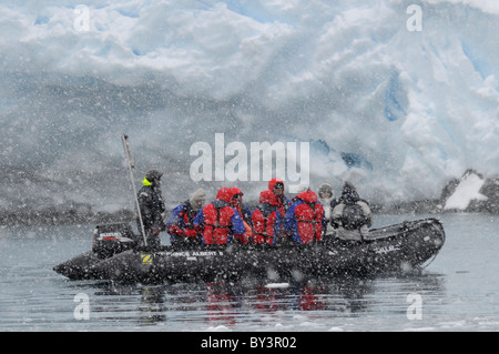 Tourists in a zodiac at Cape Renard in Lemaire Channel near Antarctic Peninsula, Antarctica Stock Photo