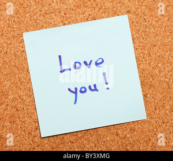 Love confession on a note paper pinned to a cork board Stock Photo