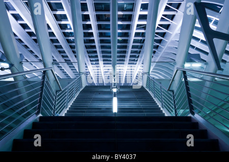 Futuristic modern architecture stairs with cold light and blue tint. Stock Photo