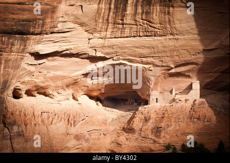 Chinle, Arizona: Fall sunlight illuminates the Mummy Cave Ruin deep in the canyons of Canyon De Chelly National Monument. Stock Photo