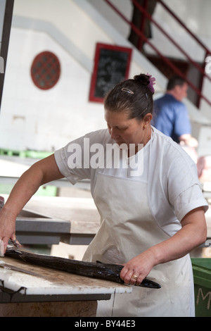 Woman fishmonger preparing fish at Funchal fish market Madeira Stock Photo