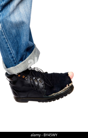 object on white - men feet in blue jeans and Damaged old boots Stock Photo