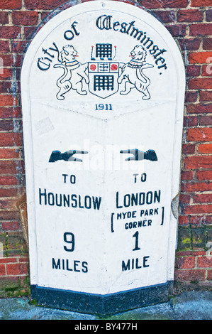 Old milestone and signpost in Kensington, London; alter wegweiser in London, Kensington mit Entfernungsangaben Stock Photo