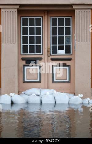 sandbags across the door of a house as protection against flooding of the river Saale in Halle (Germany); January 2011 Stock Photo