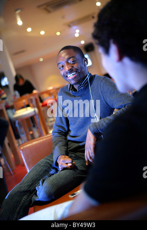 Friends socializing in university bar. Stock Photo