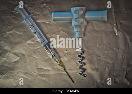 Syringe and corkscrew Stock Photo
