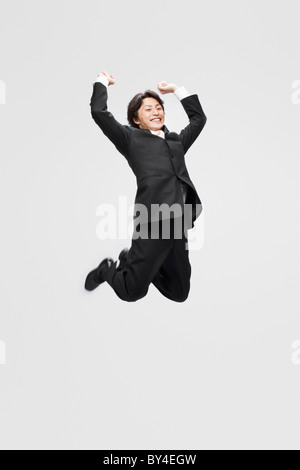 Businessman jumping in the air Stock Photo