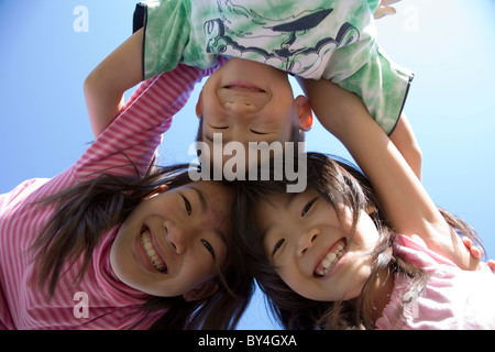 Three Children Huddling Stock Photo