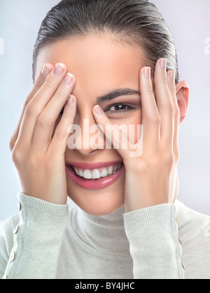 Young woman covering face with hands Stock Photo