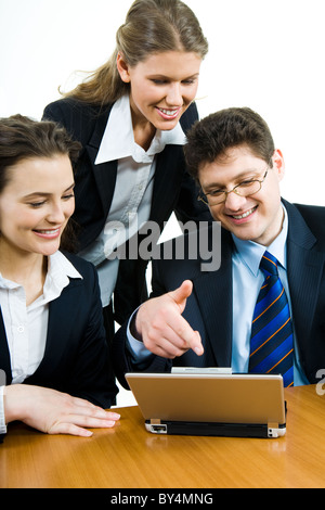 Image of confident business people looking at monitor of laptop Stock Photo