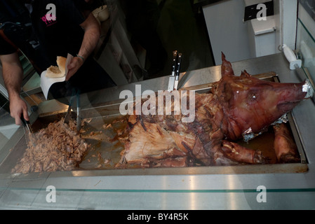 Roast pig roasted pork pig's head being carved in an Edinburgh butcher shop window Edinburgh Scotland UK Great Britain   KATHY DEWITT Stock Photo