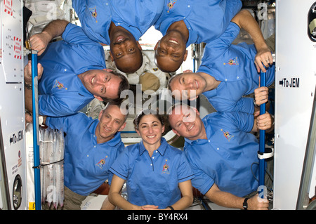 STS 129 Astronauts pose for photo in International Space Station docked to Space Shuttle Atlantis Stock Photo
